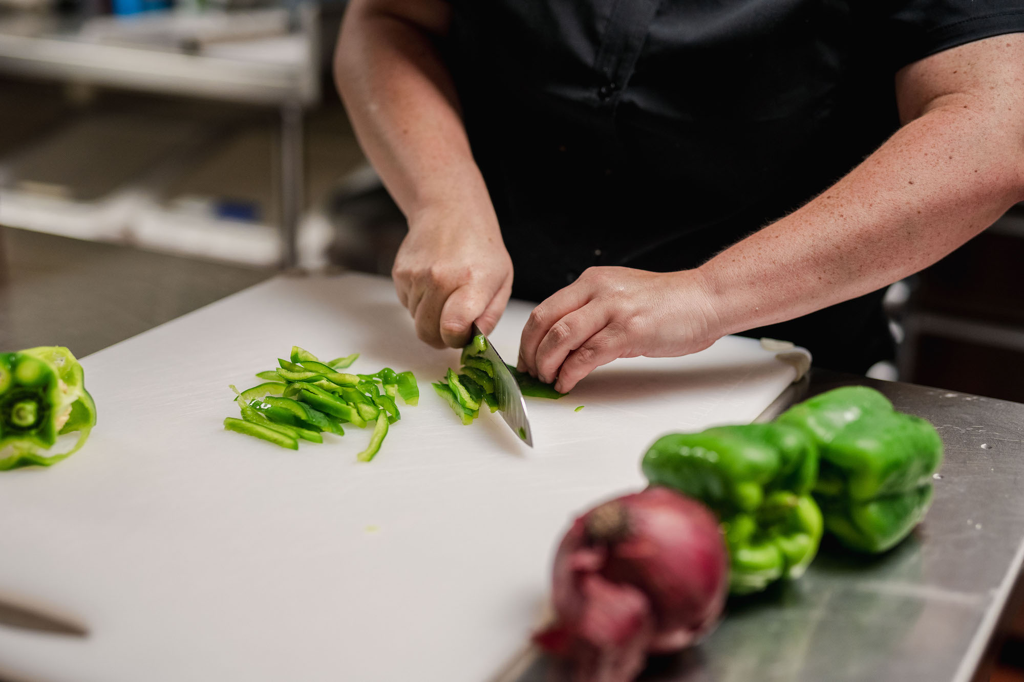 The Claiborne at Thibodaux employee walking with senior resident