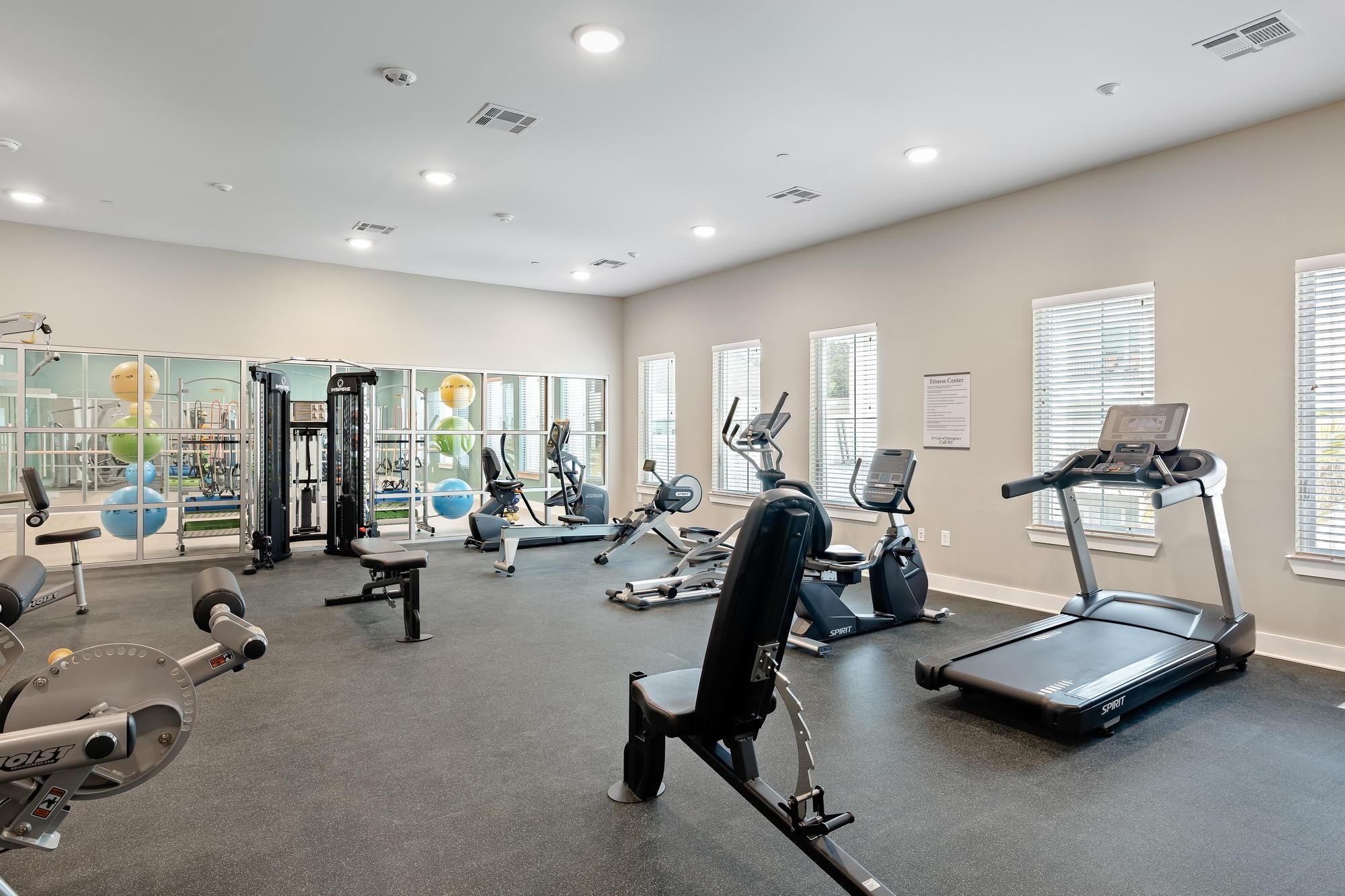The Claiborne at Brickyard Crossing fitness studio with gym equipment